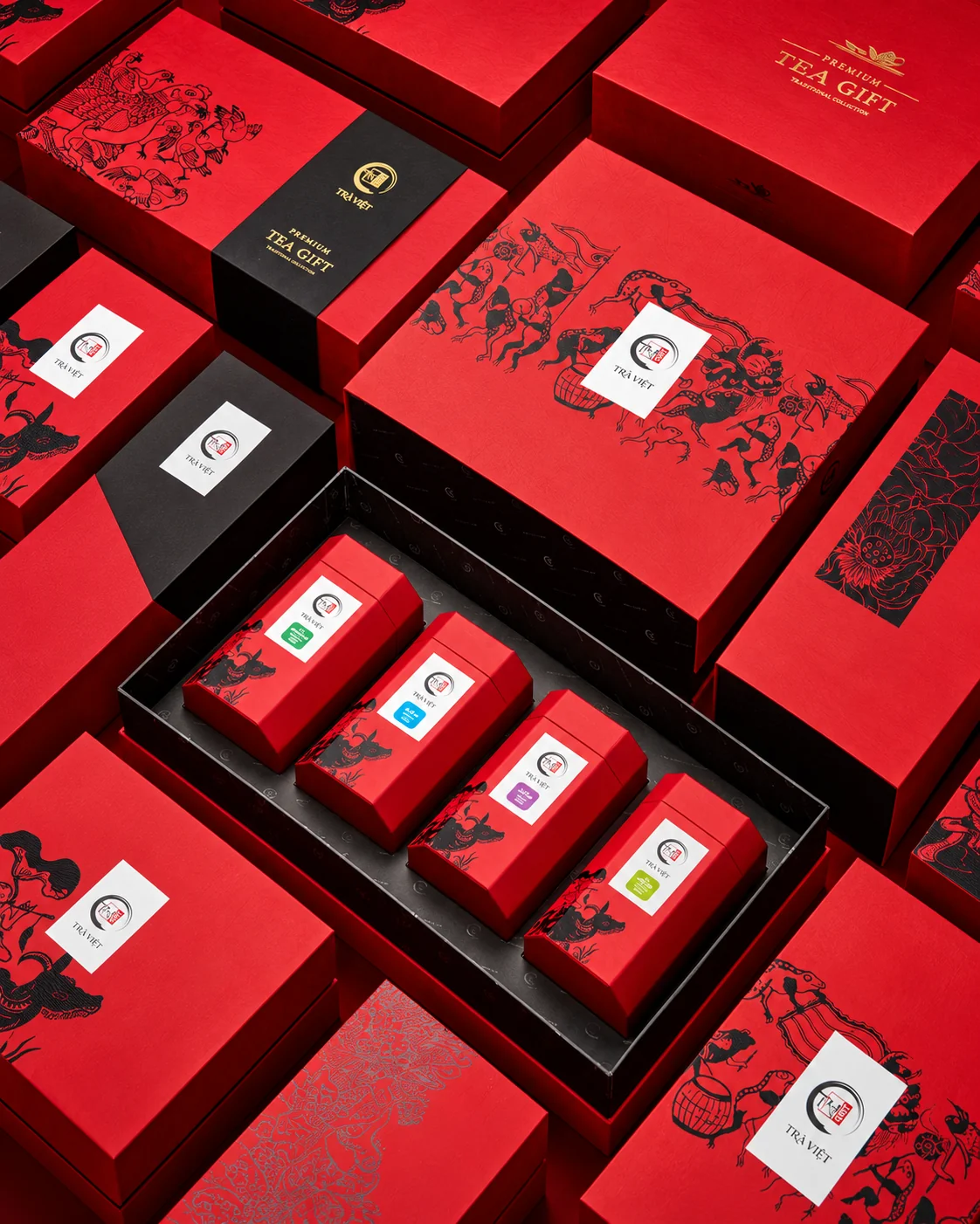 Red tea packaging and boxed products arranged for an editorial product photograph.