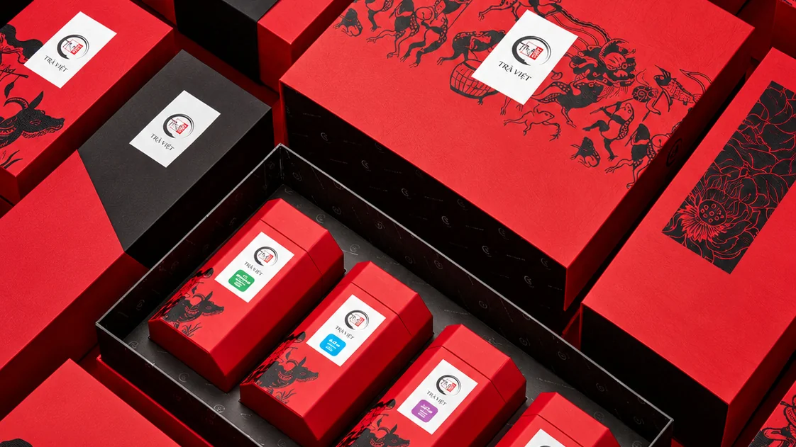 Vibrant red tea packaging and boxed products arranged together.