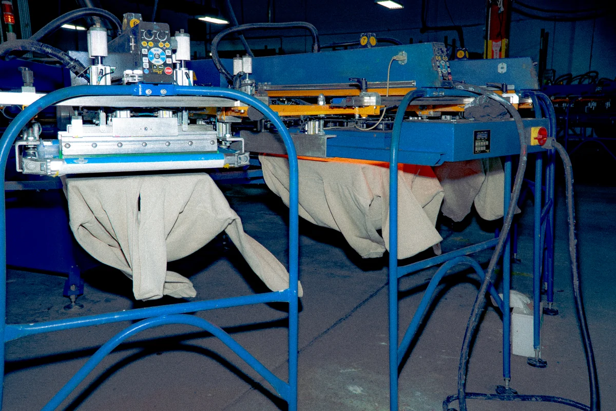 An automatic screen-printing press with garments positioned at its printing stations.