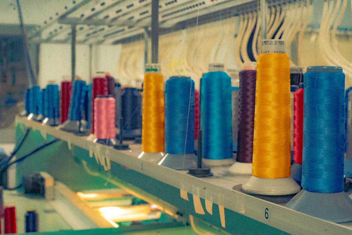 Thread feeds and work area. Editorial illustration of embroidery / thread preparation.
